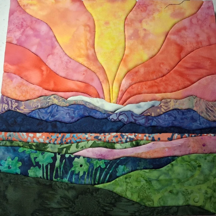 A student's first kinusaiga piece in warm corals, pinks and greens, made from the same sunrise template