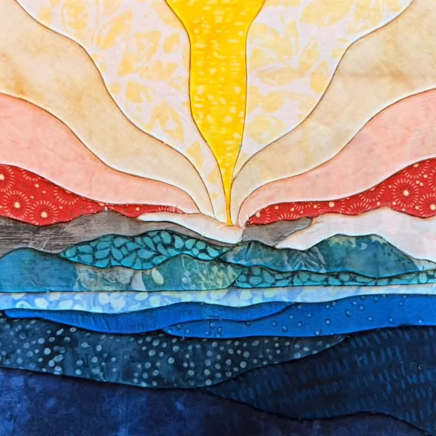 A student's first kinusaiga piece in cool blues and teals, made from the same sunrise template